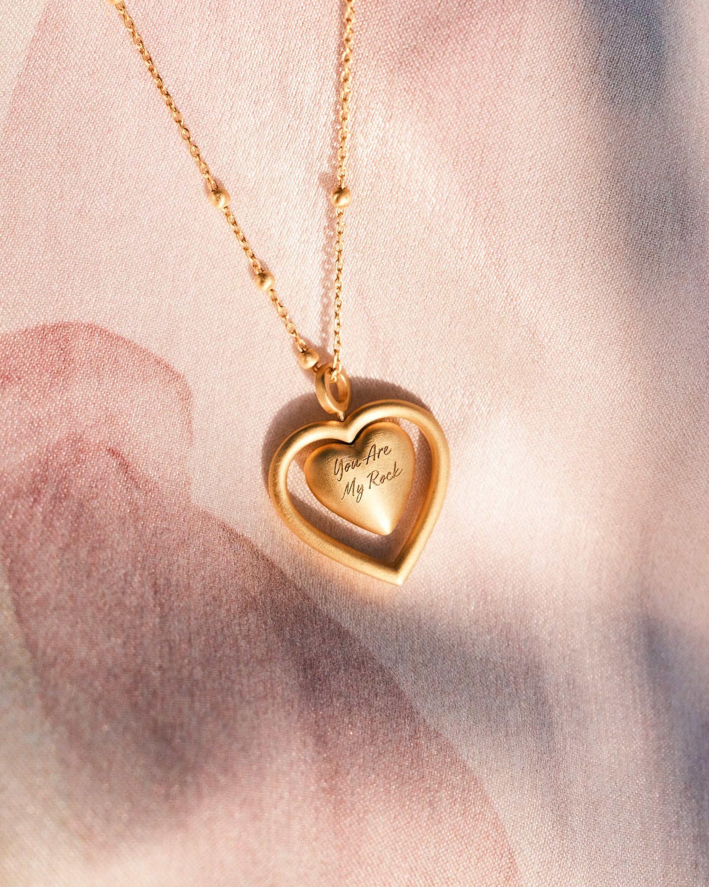 MAYA SPINNING HEART PENDANT NECKLACE